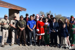 17 BLM volunteers pose for photo at toy giveaway.