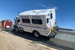 A large vehicle labeled Fort Apache Hotshots sideways on a steeply inclined ramp