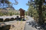 A kiosk at a campground in a scenic outdoor setting.