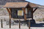 A kiosk with a hill in the desert background.