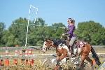 Woman jousting on a horse. 