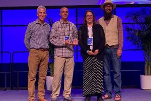 NOC AIM team with SAG Award at the 2022 Esri User Convention.