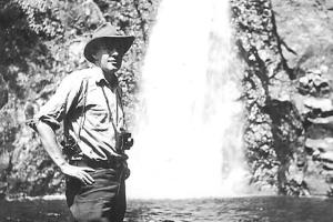 Howard Zahniser, who wrote the first draft of the Wilderness Act in 1956, by a waterfall.