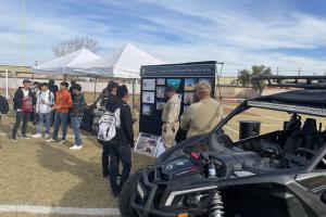 A group of BLM  employees stand in front of OHVs