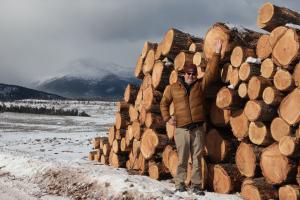 John Markalunas, a former fire management officer with the Bureau of Land Management and the U.S. Forest Service, was one of the individuals who implemented the use of the Good Neighbor Authority to complete fuels treatments on Poncha Pass. Here, he stands next to a pile of salvaged timber resulting from that project.