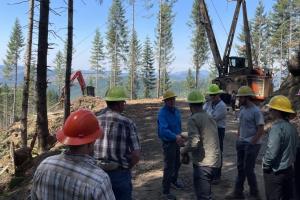 Barry Bushue meets with staff and purchaser at a timber sale in Coos Bay