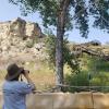 Person looking at the Pillar through binoculars. 