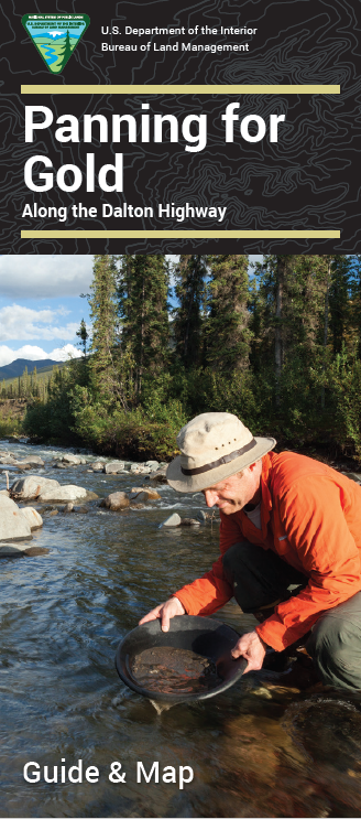 Front cover of brochure. Man pans for gold in stream.  