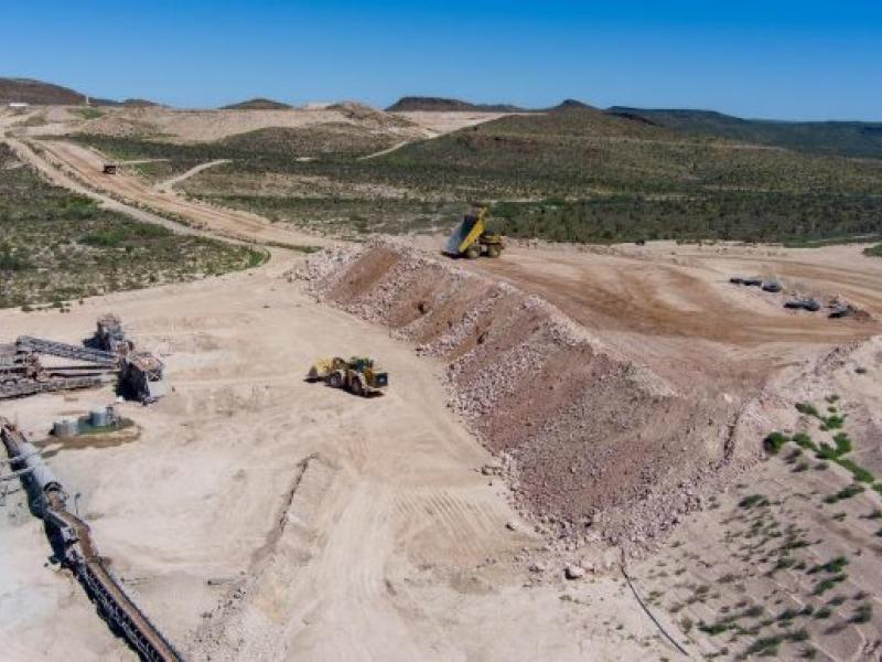 A aerial shot of an open pit mine in the desert.