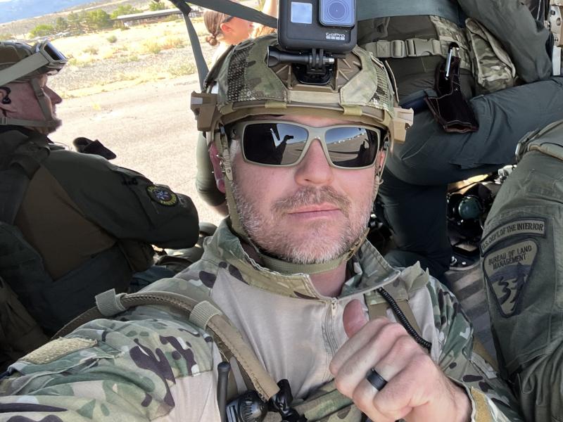 man in camp uniform and helmet takes a selfie