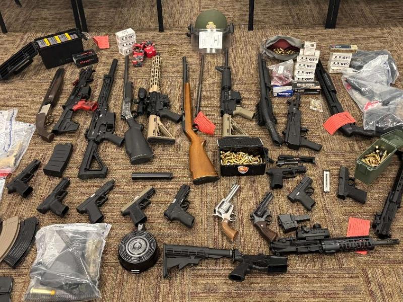 Illegal weapons laid out on the floor.