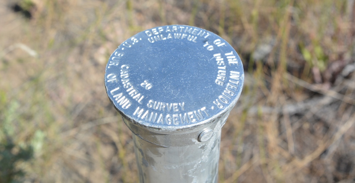 A close up of a survey pin. BLM photo.